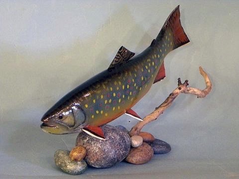 9'' Brook Trout Parr swimming over wooden rocks.