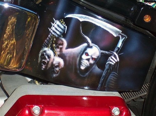 A skeleton painted on a Harley gas tank.