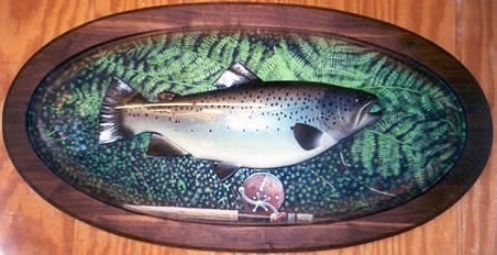 10 lbs Brown Trout lying in ferns, with an oval Walnut frame mounted behind an acrylic dome.