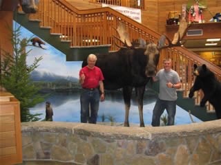 The artist next to the moose.